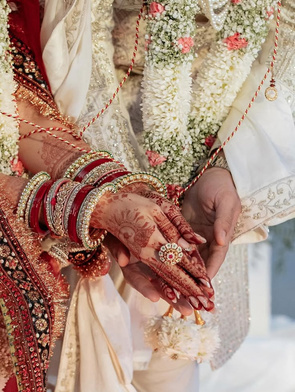 Bridal hands with mehendi and red bangles