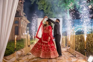Couple dancing amid sparkler fountains